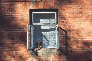 an image of an open window on a brick wall