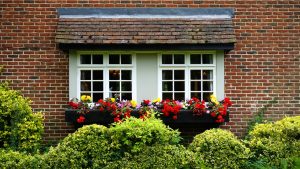 a spring home with flowers and shrubs to improve home security